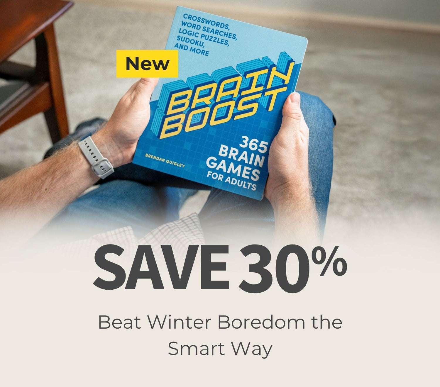 Person holding a 'Brain Boost' book with promotional text about saving 30% on brain games.